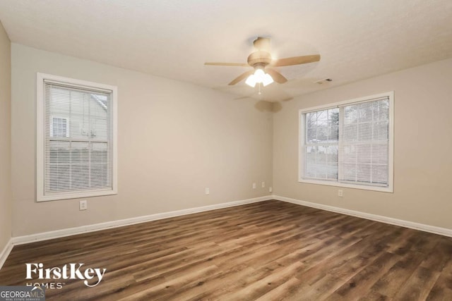 spare room featuring dark hardwood / wood-style flooring and ceiling fan