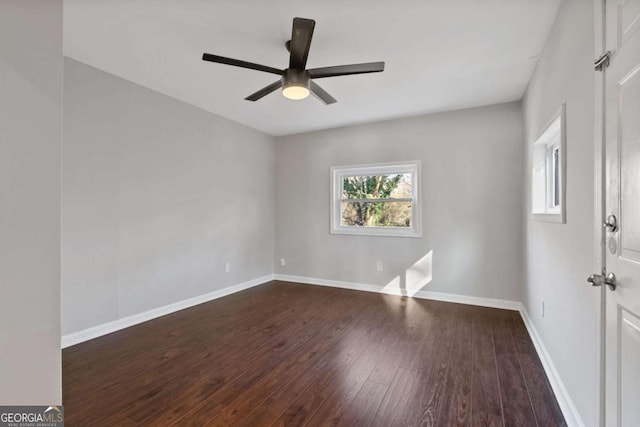 empty room featuring ceiling fan and dark hardwood / wood-style floors