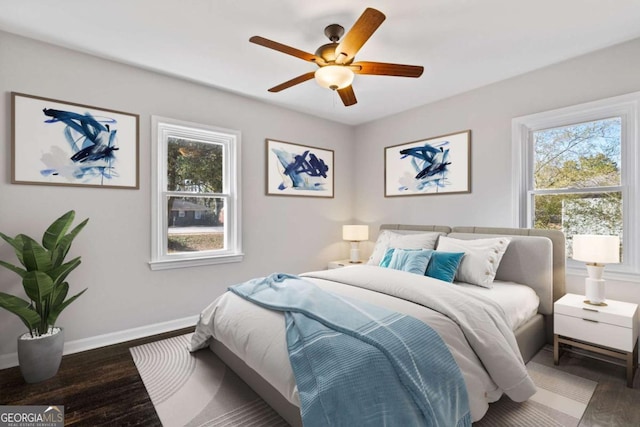 bedroom with dark wood-type flooring and ceiling fan