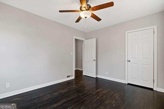 unfurnished bedroom with dark hardwood / wood-style floors and ceiling fan