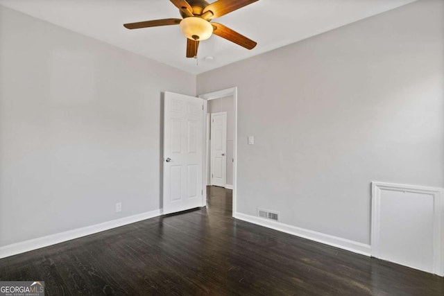 unfurnished room with ceiling fan and dark hardwood / wood-style floors