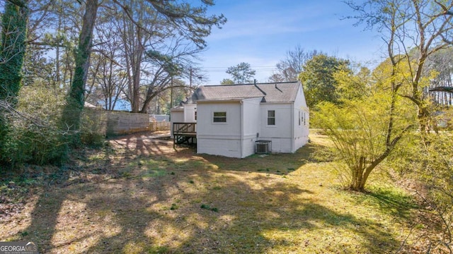 back of house with a yard and central AC unit