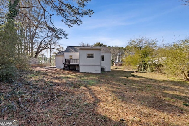 rear view of house featuring a wooden deck