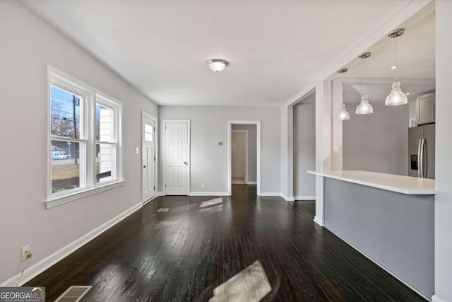 unfurnished living room with dark hardwood / wood-style floors