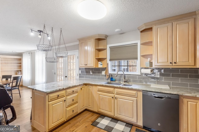 kitchen featuring sink, light wood-type flooring, black dishwasher, kitchen peninsula, and light stone countertops