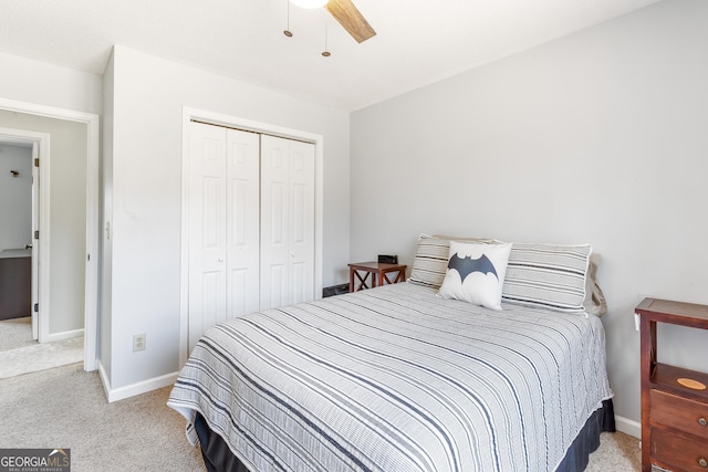 bedroom featuring light carpet, ceiling fan, and a closet