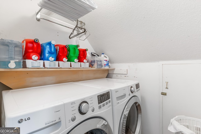 laundry room with washer and clothes dryer and a textured ceiling