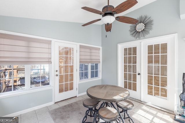 sunroom featuring lofted ceiling, ceiling fan, and french doors