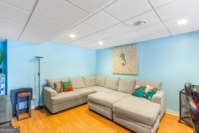 living room with wood-type flooring and a paneled ceiling