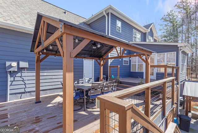 wooden deck featuring a gazebo and ceiling fan