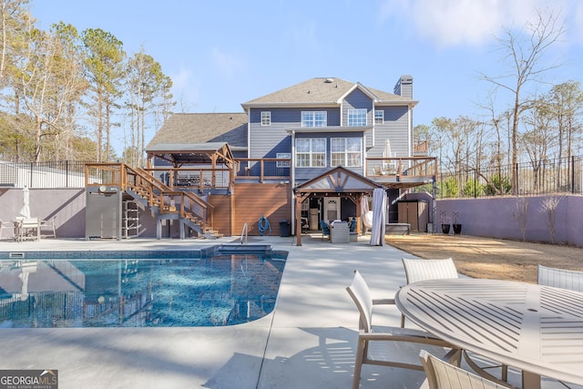 view of swimming pool featuring a wooden deck and a patio area