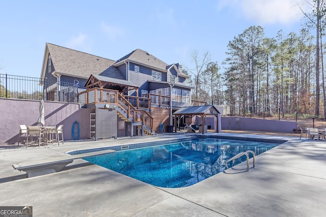 view of swimming pool with a patio, a gazebo, and a diving board