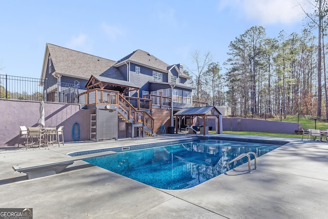 view of swimming pool with a gazebo, a diving board, and a patio