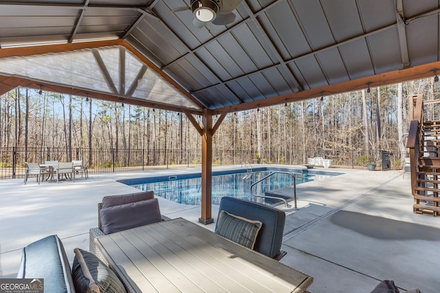 view of pool with a patio and ceiling fan