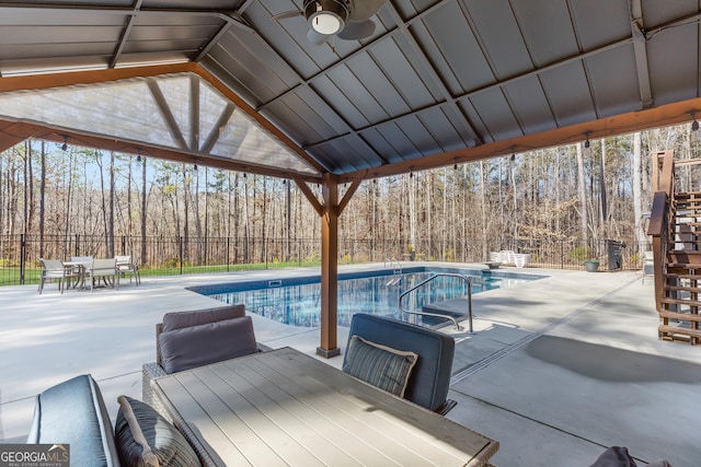 view of pool featuring ceiling fan and a patio