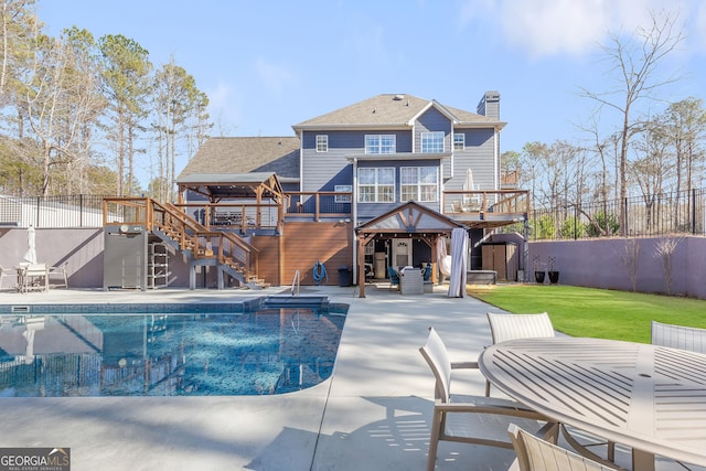 view of pool featuring a yard, a deck, and a patio area