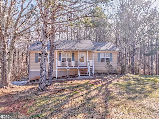 ranch-style house with a front lawn and a porch