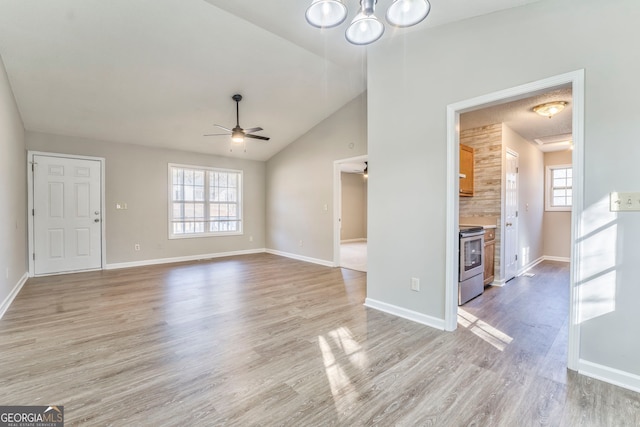 unfurnished living room featuring light hardwood / wood-style flooring, ceiling fan, and vaulted ceiling