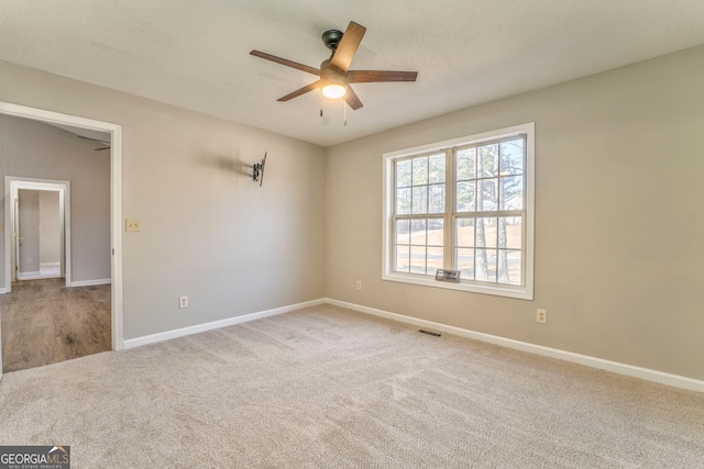 carpeted empty room featuring ceiling fan