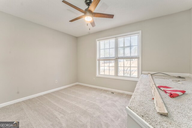 unfurnished bedroom with light carpet and ceiling fan