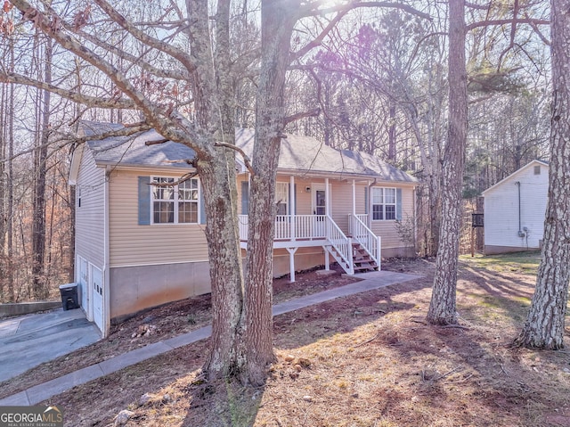 single story home with a garage and covered porch