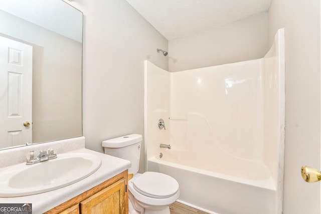 full bathroom featuring shower / tub combination, vanity, a textured ceiling, and toilet