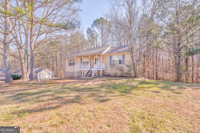 single story home featuring covered porch and a front lawn