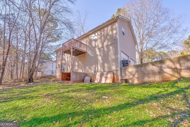 back of property with a balcony and a lawn