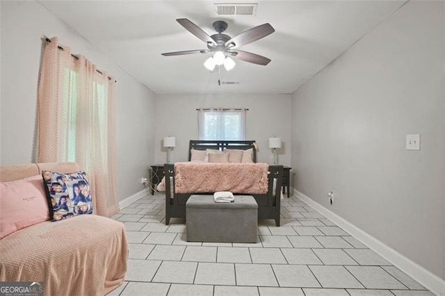 tiled bedroom featuring ceiling fan