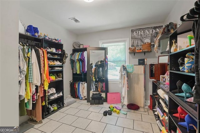 spacious closet featuring light tile patterned flooring