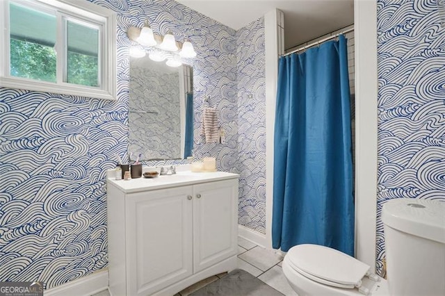 bathroom featuring vanity, a notable chandelier, and toilet