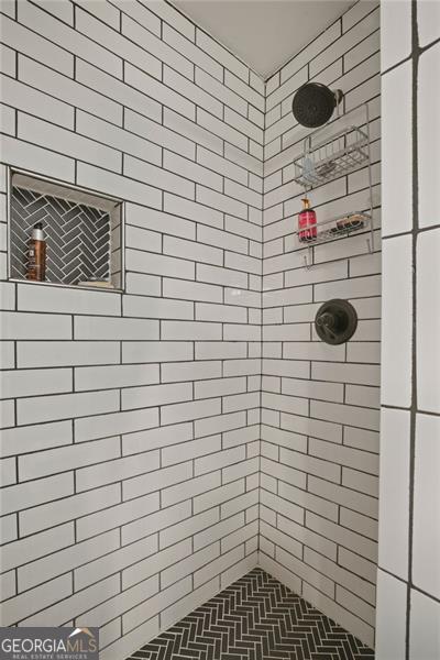 bathroom with tiled shower