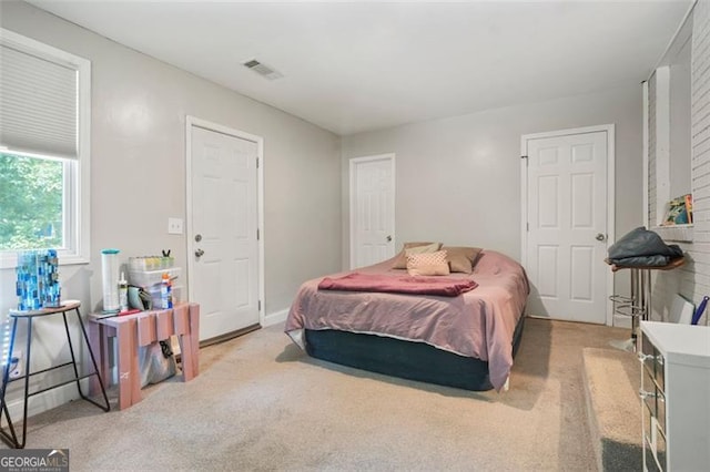 bedroom featuring light colored carpet