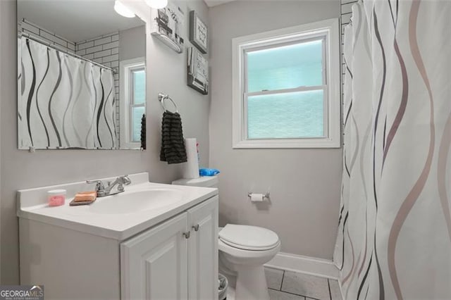 bathroom with vanity, tile patterned floors, and toilet