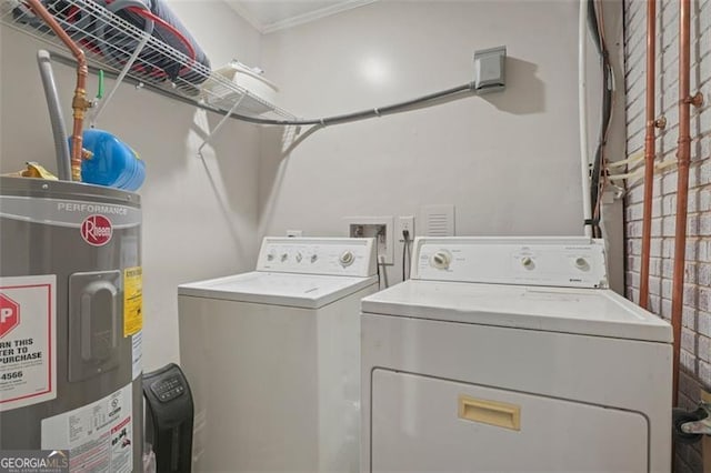 washroom featuring water heater, ornamental molding, and washer and clothes dryer