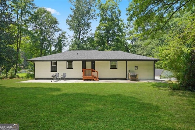 rear view of house featuring a yard and a patio area