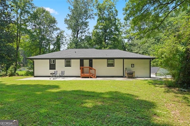 back of property featuring a yard and a patio area