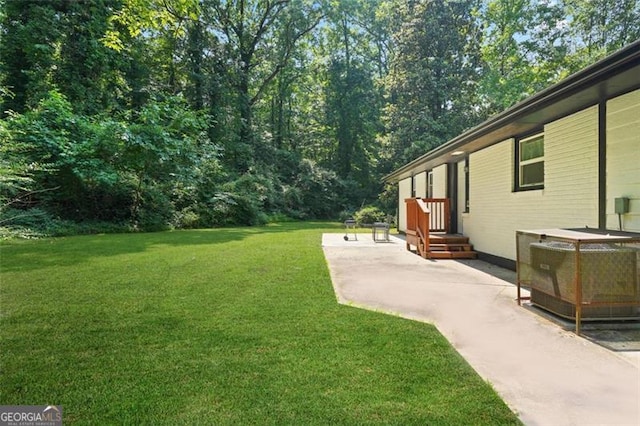 view of yard featuring cooling unit and a patio area