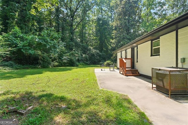 view of yard featuring central AC unit and a patio area