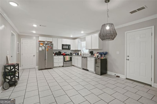 kitchen featuring crown molding, hanging light fixtures, light tile patterned floors, stainless steel appliances, and white cabinets