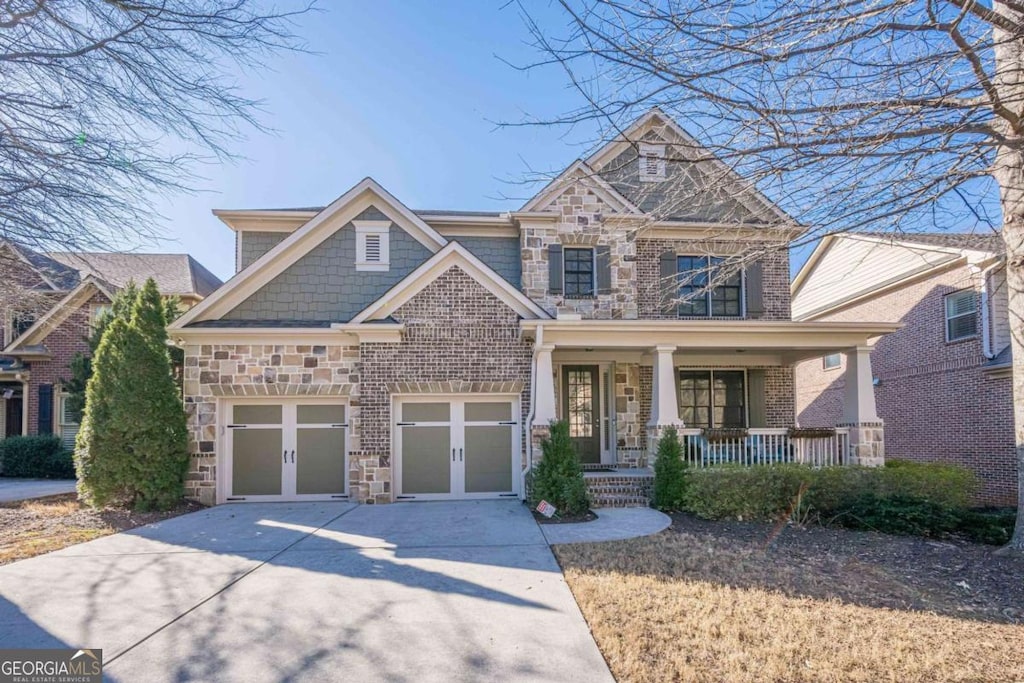 craftsman house featuring a garage and a porch