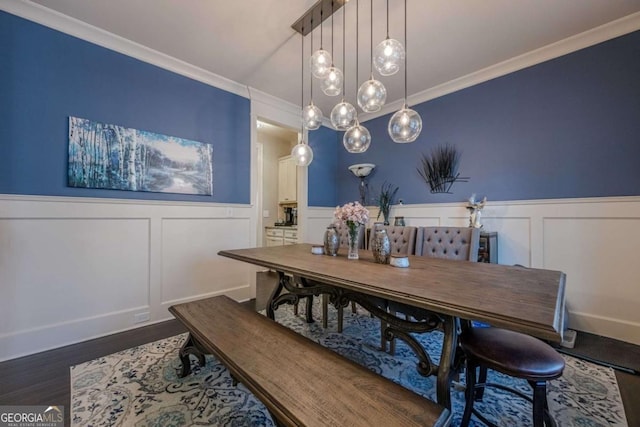 dining area featuring ornamental molding and dark hardwood / wood-style flooring