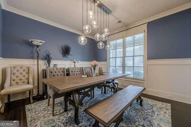 dining space with ornamental molding and dark hardwood / wood-style flooring