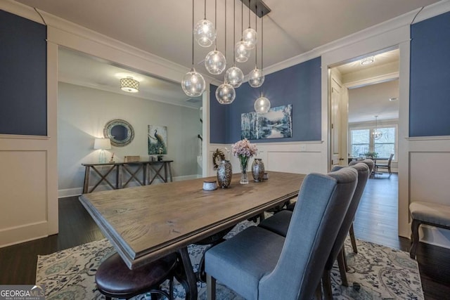 dining space featuring ornamental molding and dark hardwood / wood-style flooring