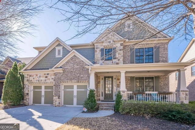 craftsman inspired home with a garage and covered porch