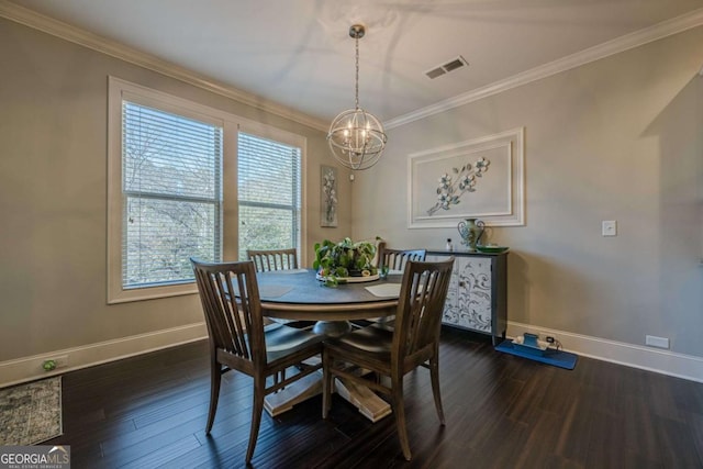 dining room featuring dark hardwood / wood-style flooring, a notable chandelier, and crown molding