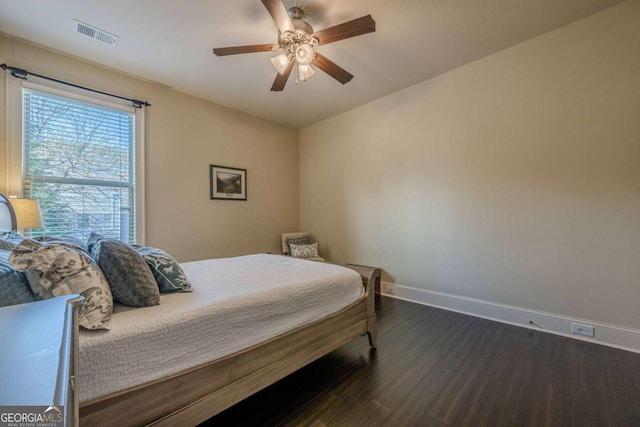 bedroom with dark hardwood / wood-style floors and ceiling fan