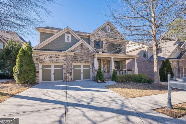 craftsman house with a garage, covered porch, and french doors