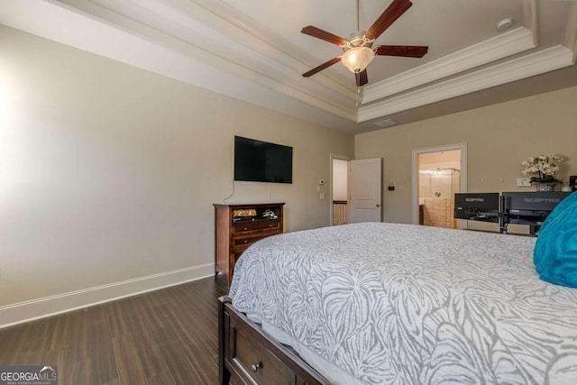 bedroom with ceiling fan, ornamental molding, dark hardwood / wood-style floors, and a raised ceiling