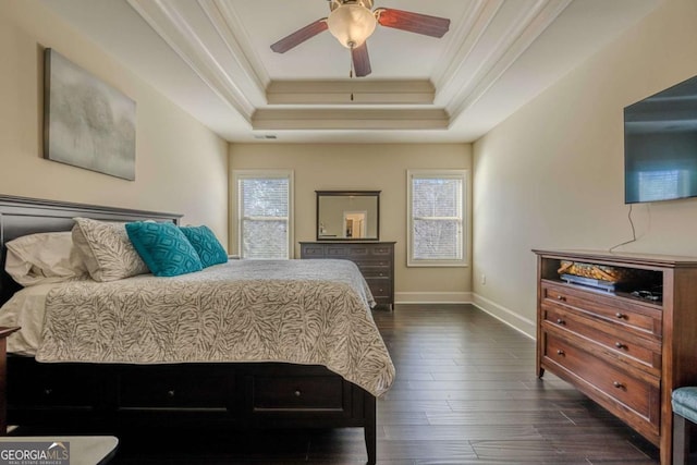 bedroom featuring a raised ceiling, ornamental molding, ceiling fan, and dark hardwood / wood-style flooring